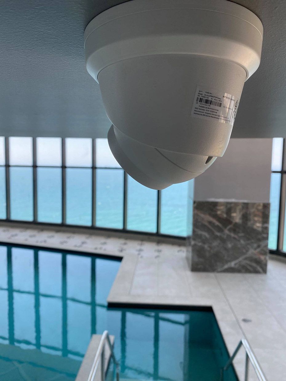 A Ceiling Mounted Camera Over a Swimming Pool — SPL Security Solutions In Bundall, QLD