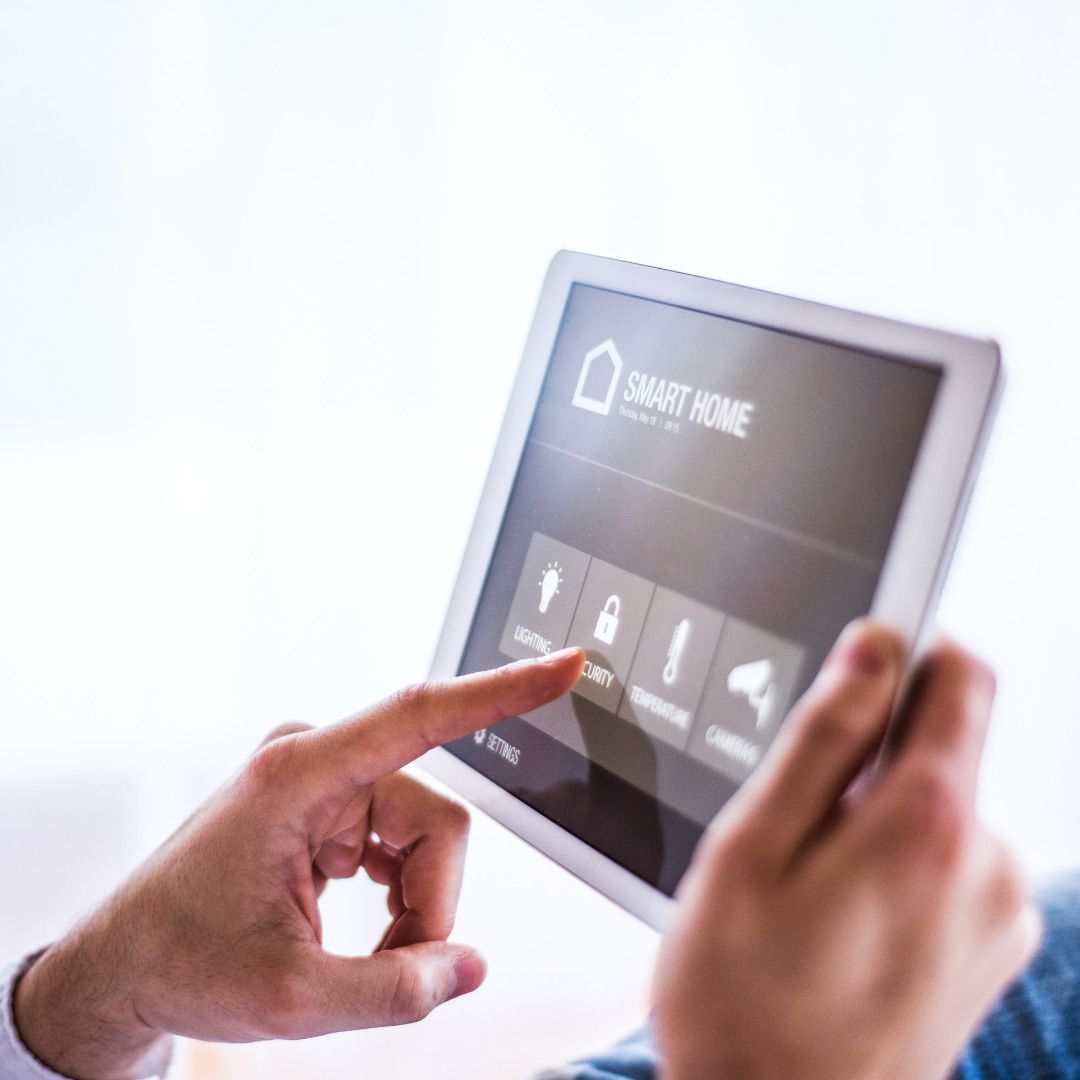 A Person is Using a Tablet With a Smart Home App on It — SPL Security Solutions In Coomera, QLD
