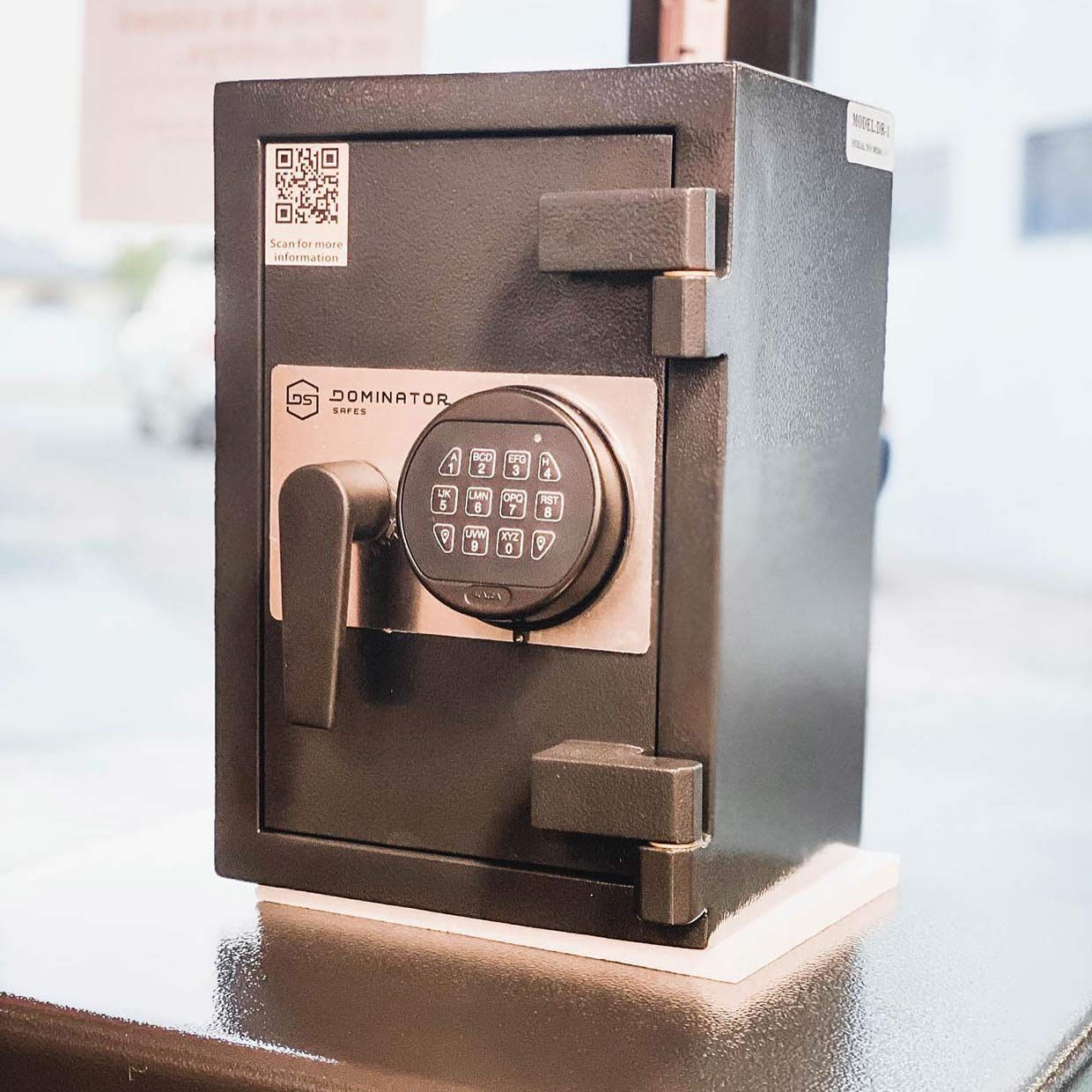A Safe With a Digital Lock is Sitting on a Table — SPL Security Solutions In Tweed Heads, NSW