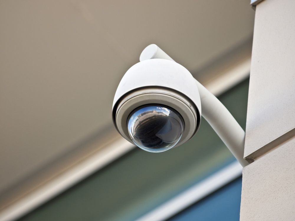 A Security Camera Is Mounted On The Side Of A Building — SPL Security Solutions in Bundall, QLD