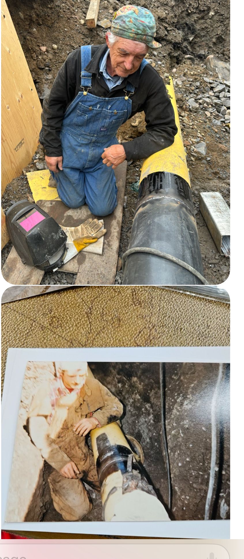 Man kneeling, working on a pipe in a ditch. Welding mask, printed photo also in view.