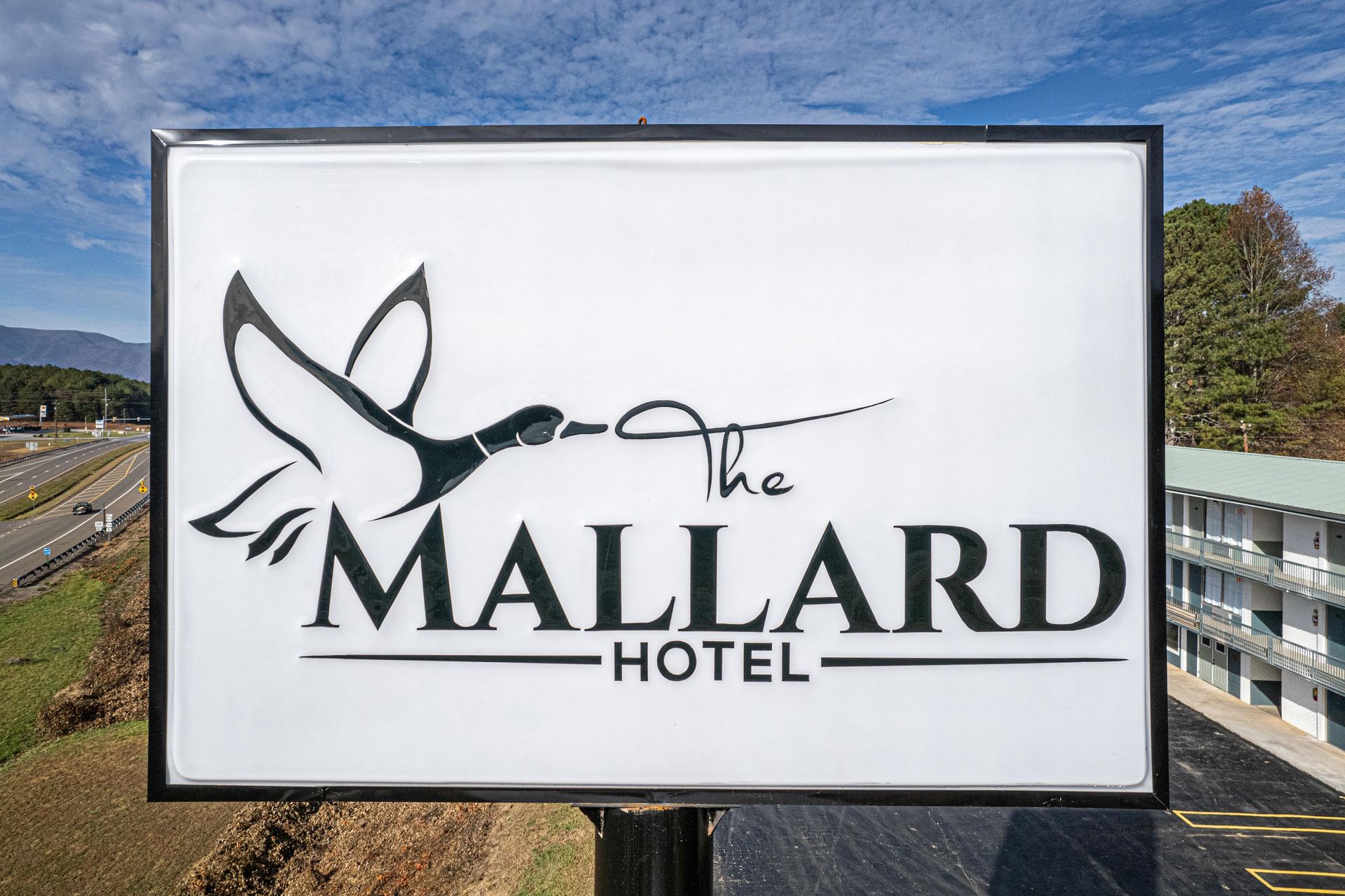 Sign for The Mallard Hotel with a flying duck logo.