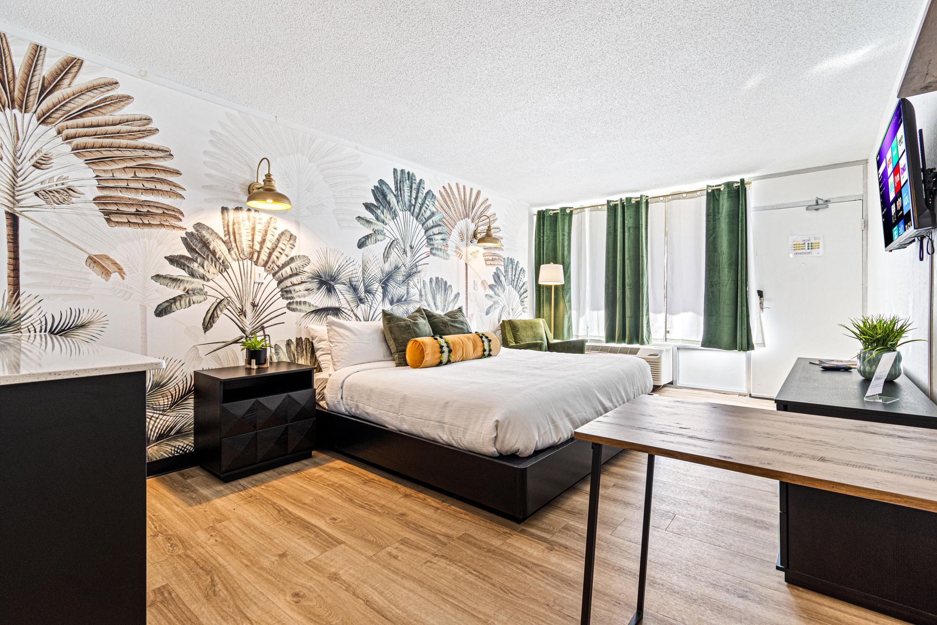 suite with king sized bed and flat screen tv
