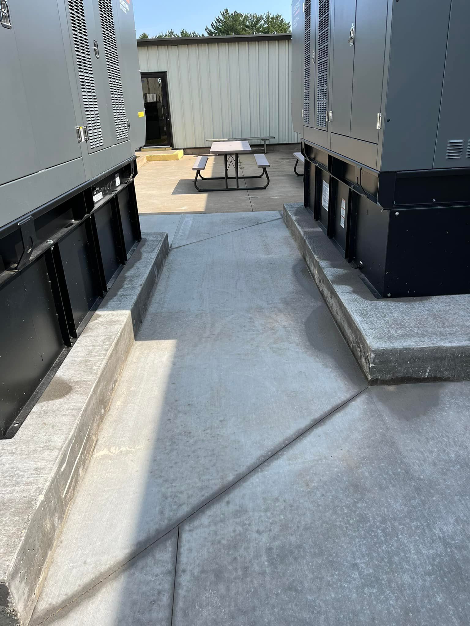 Picture of a concrete slab that was built by Leland Construction and Concrete. You can see a square concrete pad in a back yard here in Eau Clarie, WI.