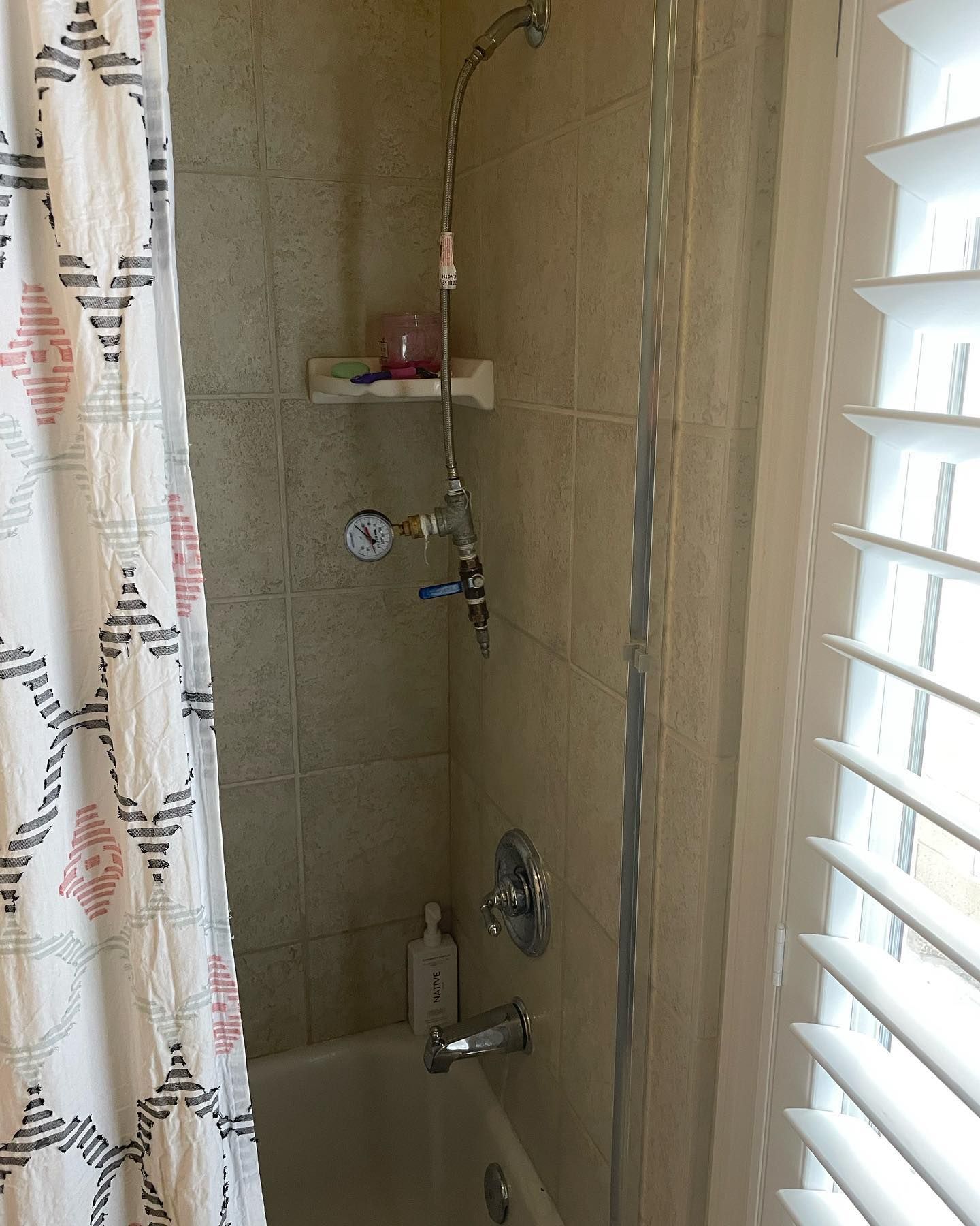 a shower with a bathtub and a shower head