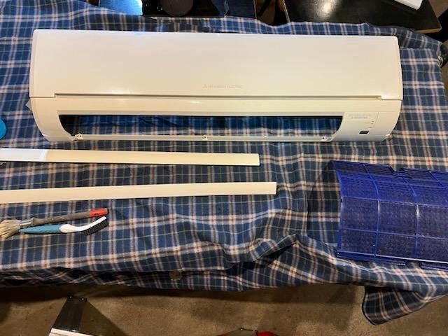 A White Air Conditioner Is Sitting On Top Of A Blue Plaid Table Cloth — More Clean Air In Hunter Valley, NSW
