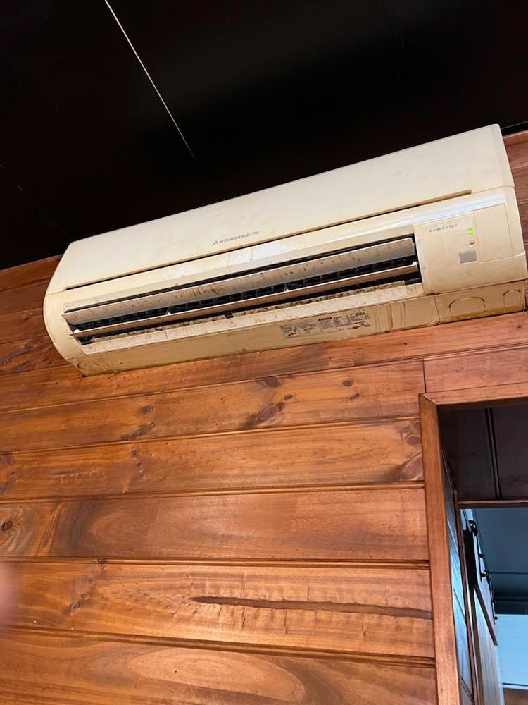 A White Air Conditioner Is Hanging On A Wooden Wall — More Clean Air In Morisset, NSW