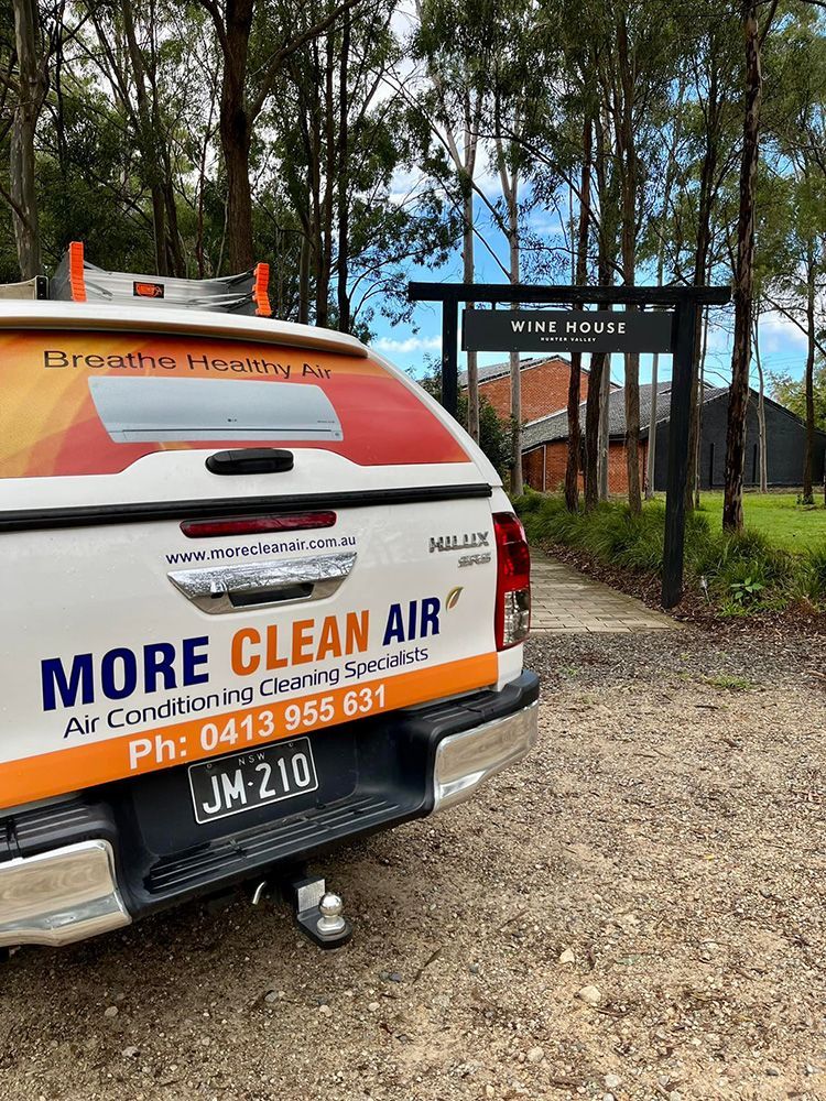 A White Truck That Is Parked In A Gravel Driveway — More Clean Air In Newcastle, NSW