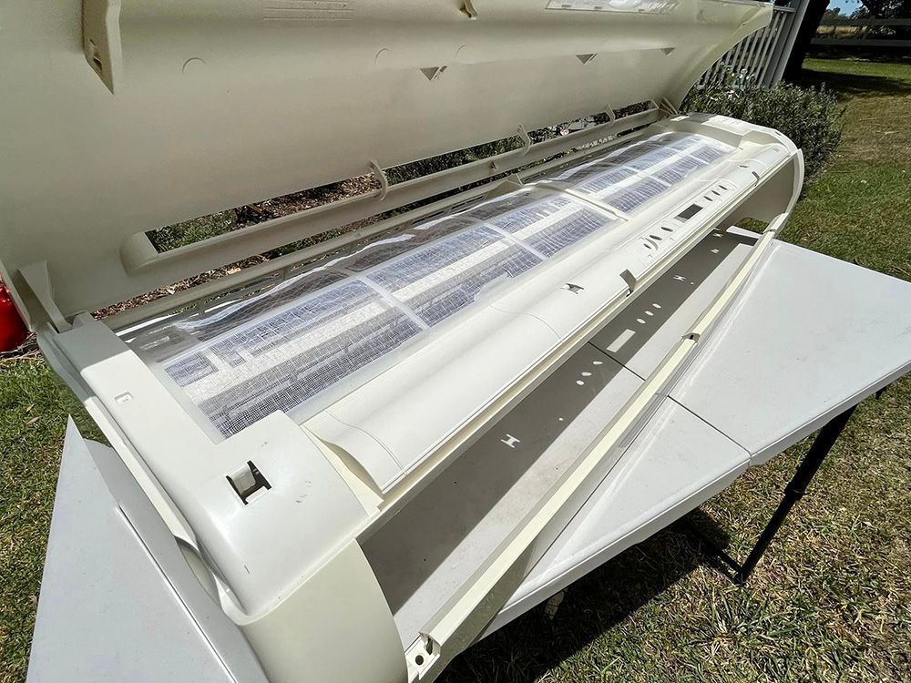 A White Air Conditioner Is Sitting On Top Of A White Table — More Clean Air In Lake Macquarie, NSW