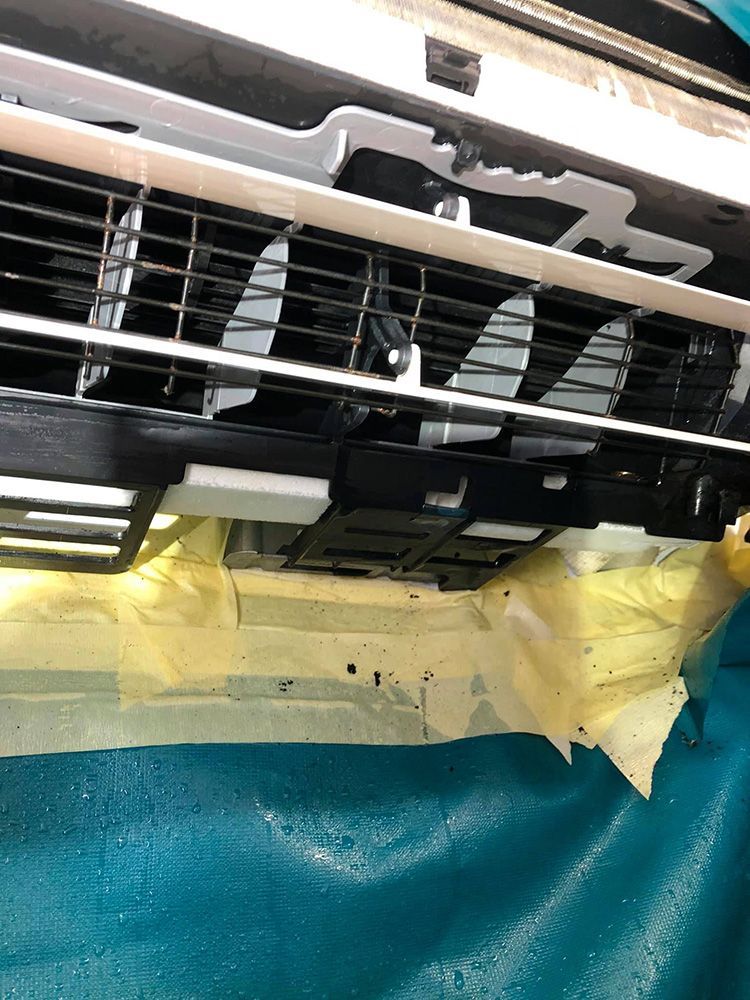 A Close Up Of The Inside Of An Air Conditioner With Tape On It — More Clean Air In Cessnock, NSW