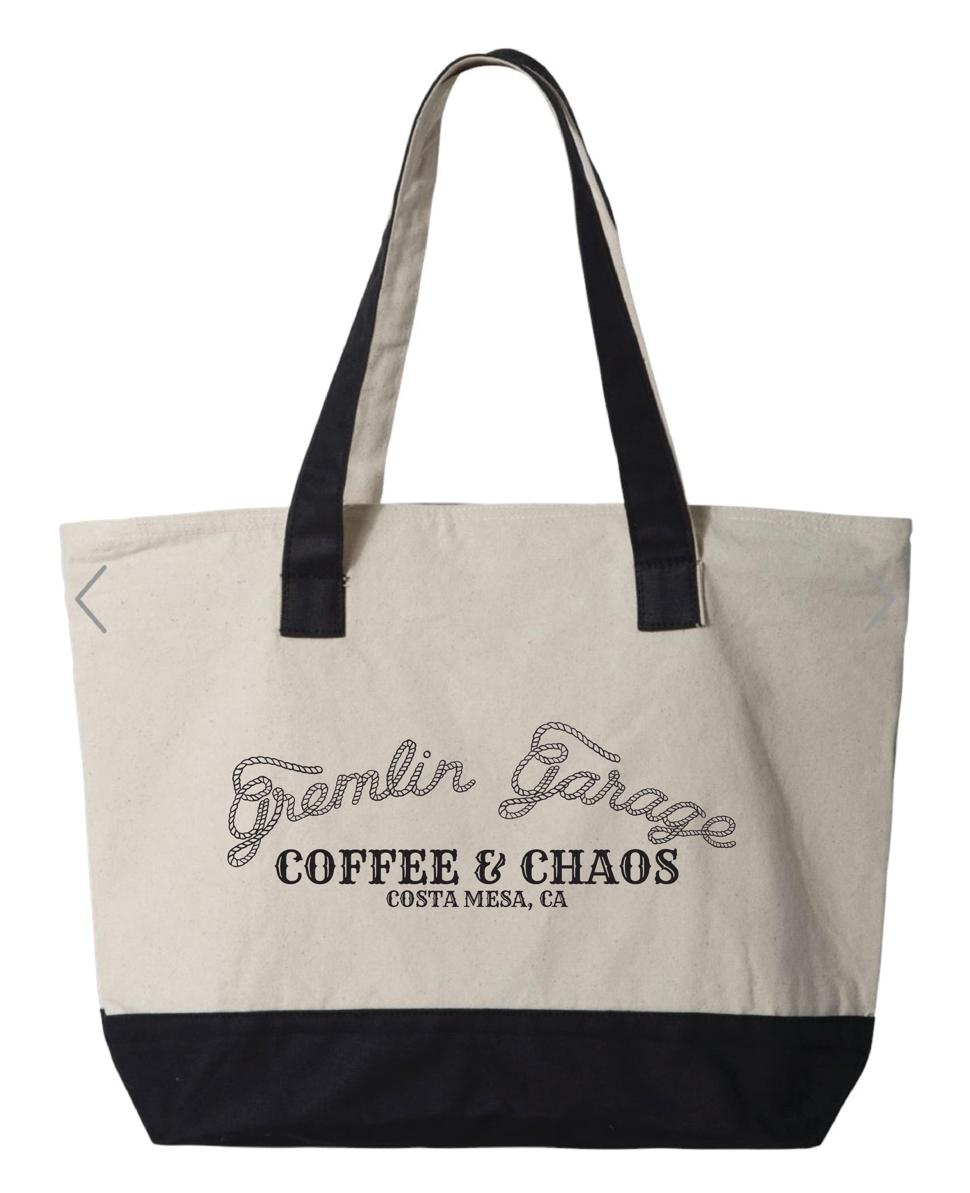 A cream-colored canvas tote bag with black handles and a black bottom base, featuring 