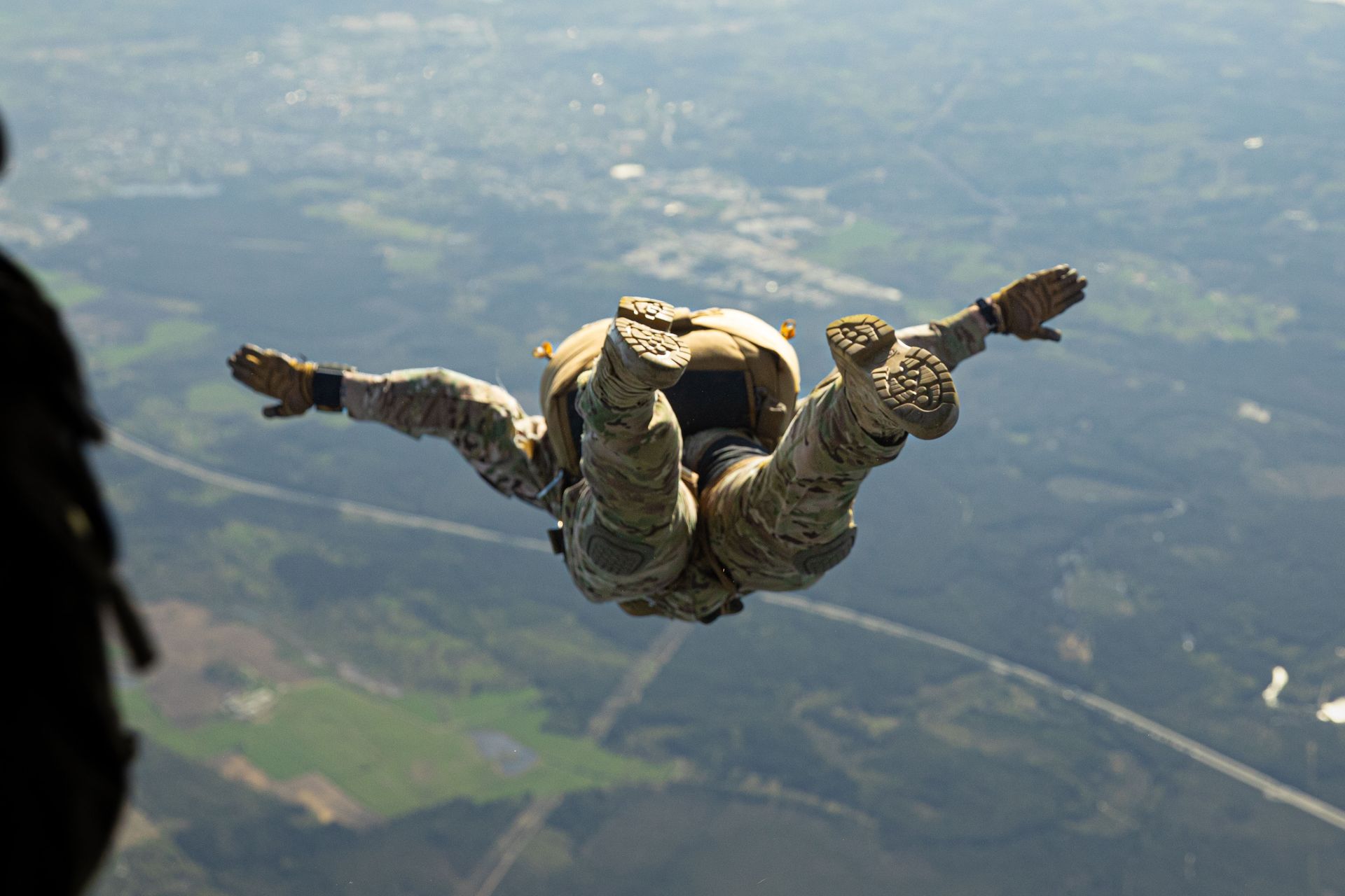 Paratrooper freefalling from the sky, symbolizing precision, transition, and mission planning

