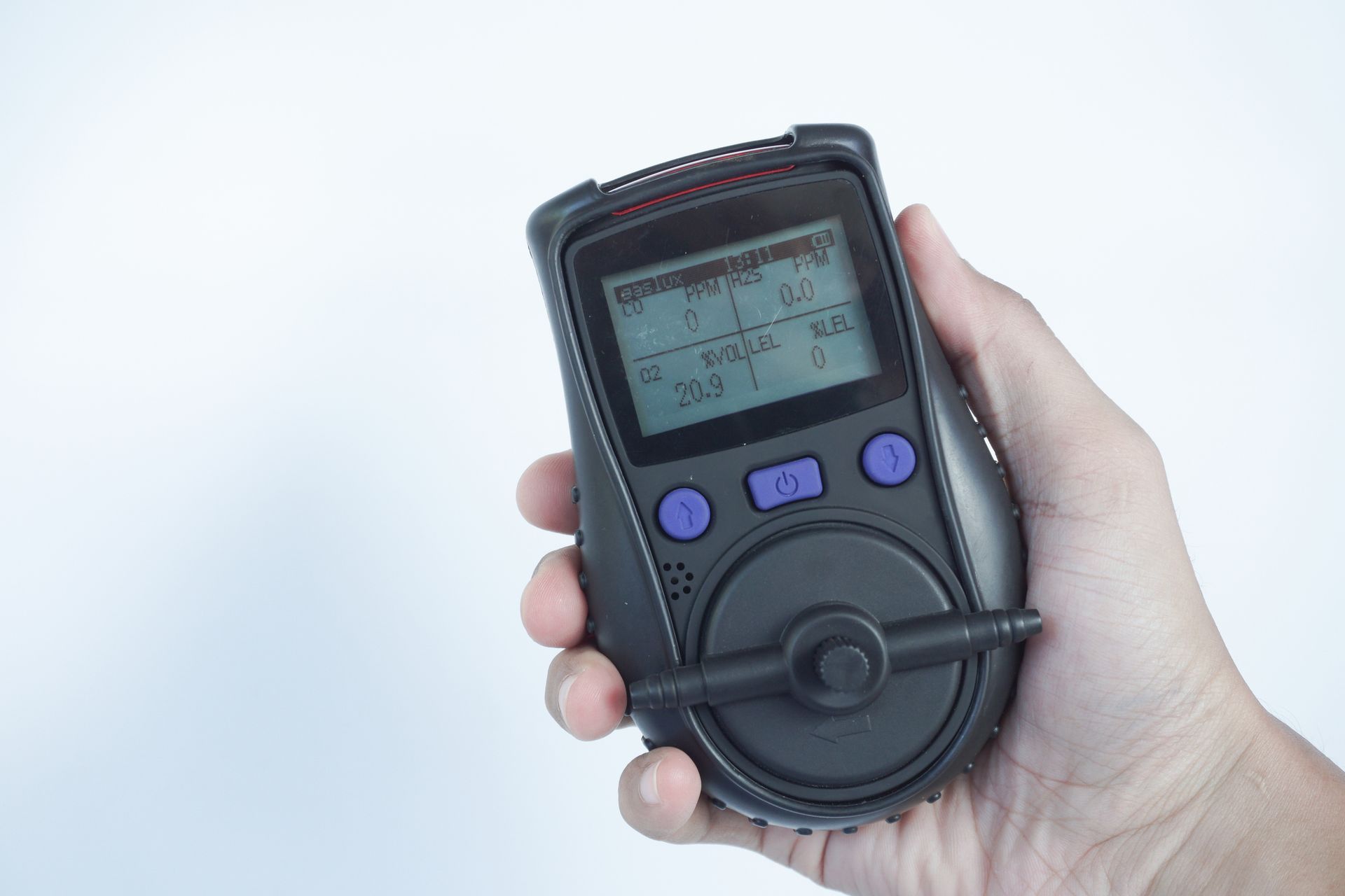 Hand holds gas detector showing digital gas concentration levels. Hand holds gas detector showing digital gas concentration levels.