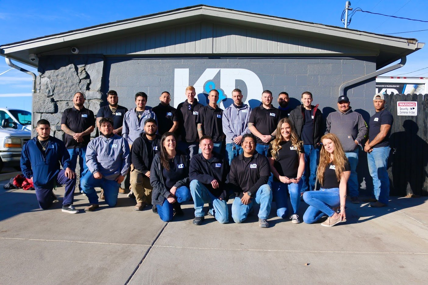 Group of people posing in front of a building with
