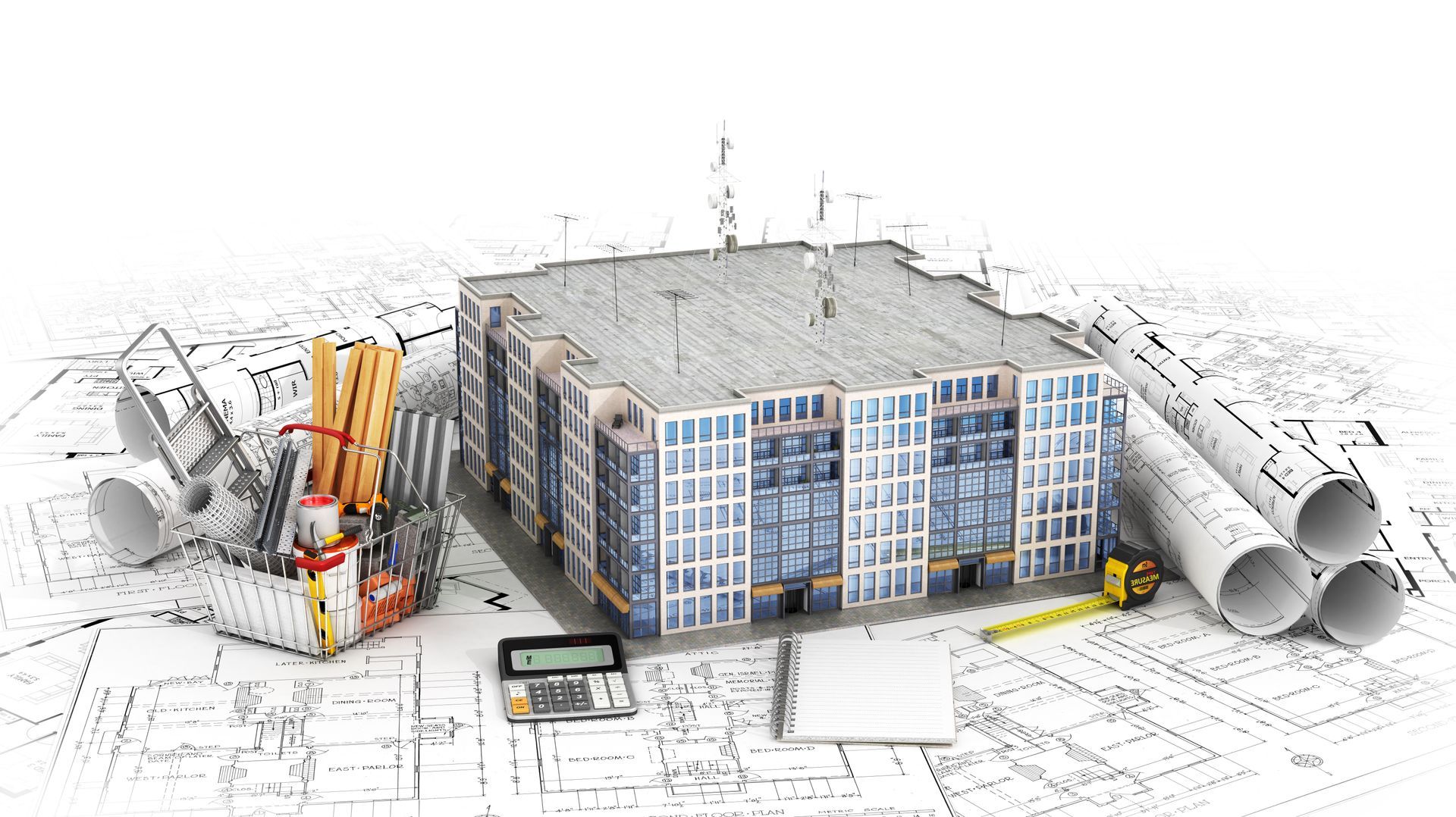 Building model on blueprints with tools and rolls of plans.