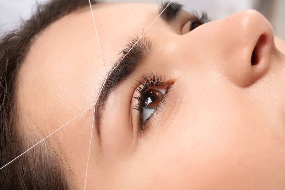 Woman Getting Her Eyebrows Threaded — Paradiso Skin & Beauty Studio in Byron Bay, NSW