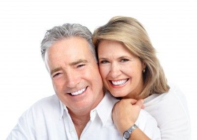 A man and a woman are smiling for the camera.