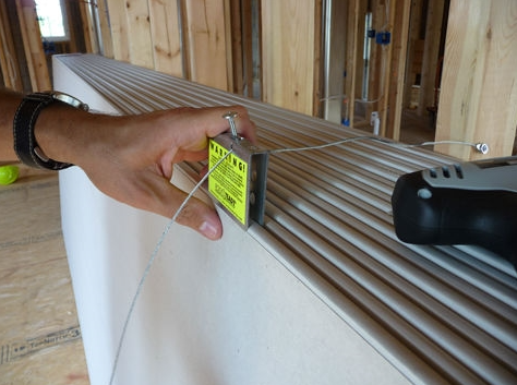 Drywall stabilizing clip being installed