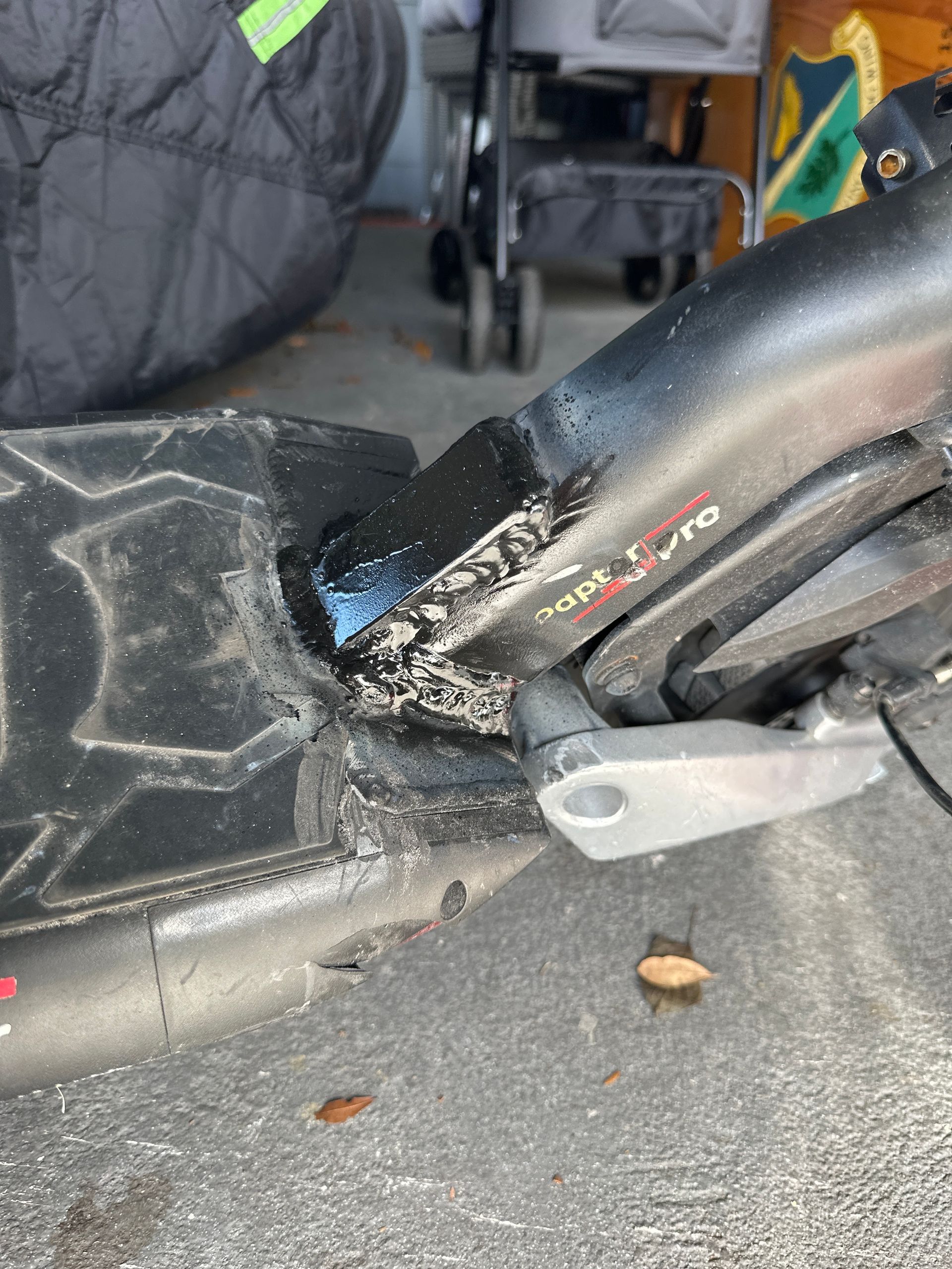 A close up of a scooter 's fender on the ground.