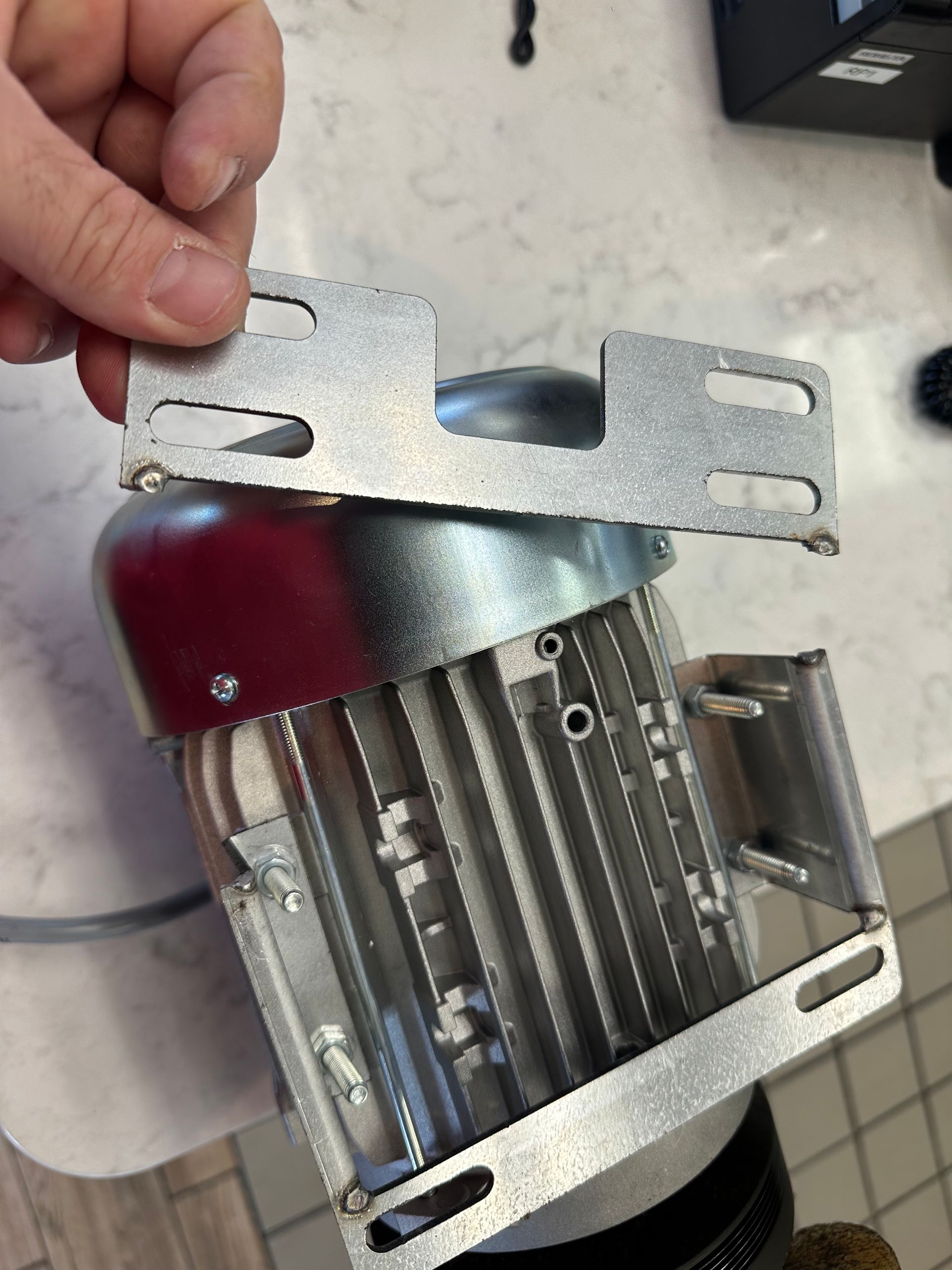 A person is holding a piece of metal in their hand.