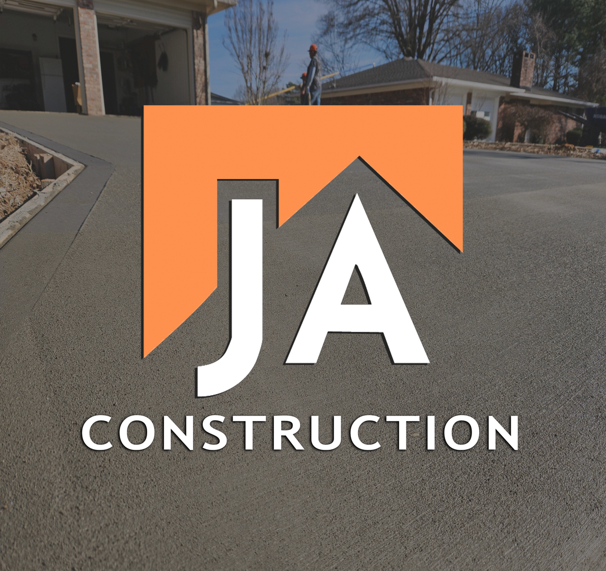 The logo for ja construction is on a concrete driveway