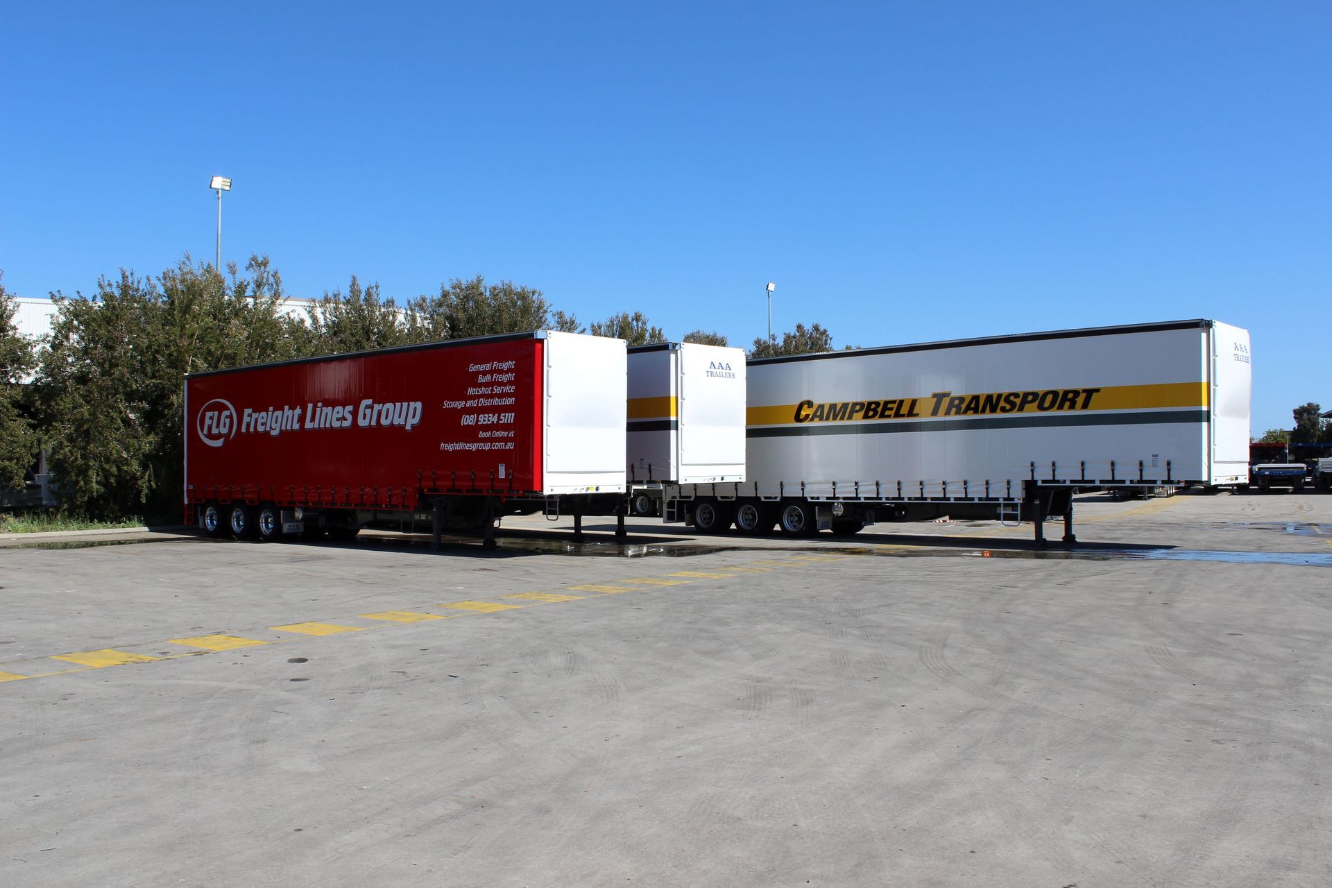 Two semi-trucks parked in a parking lot