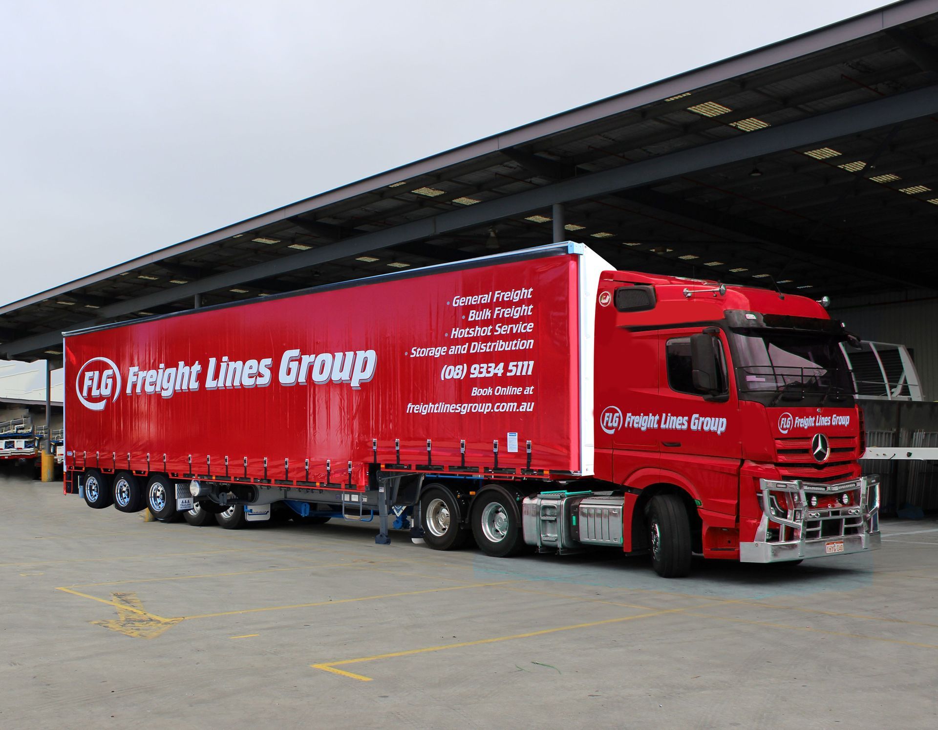 A red freight lines group truck in a parking lot