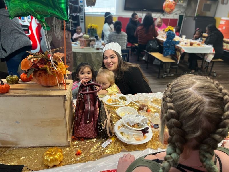 Kids at a decorated table with candy, smiling in a festive indoor party setting