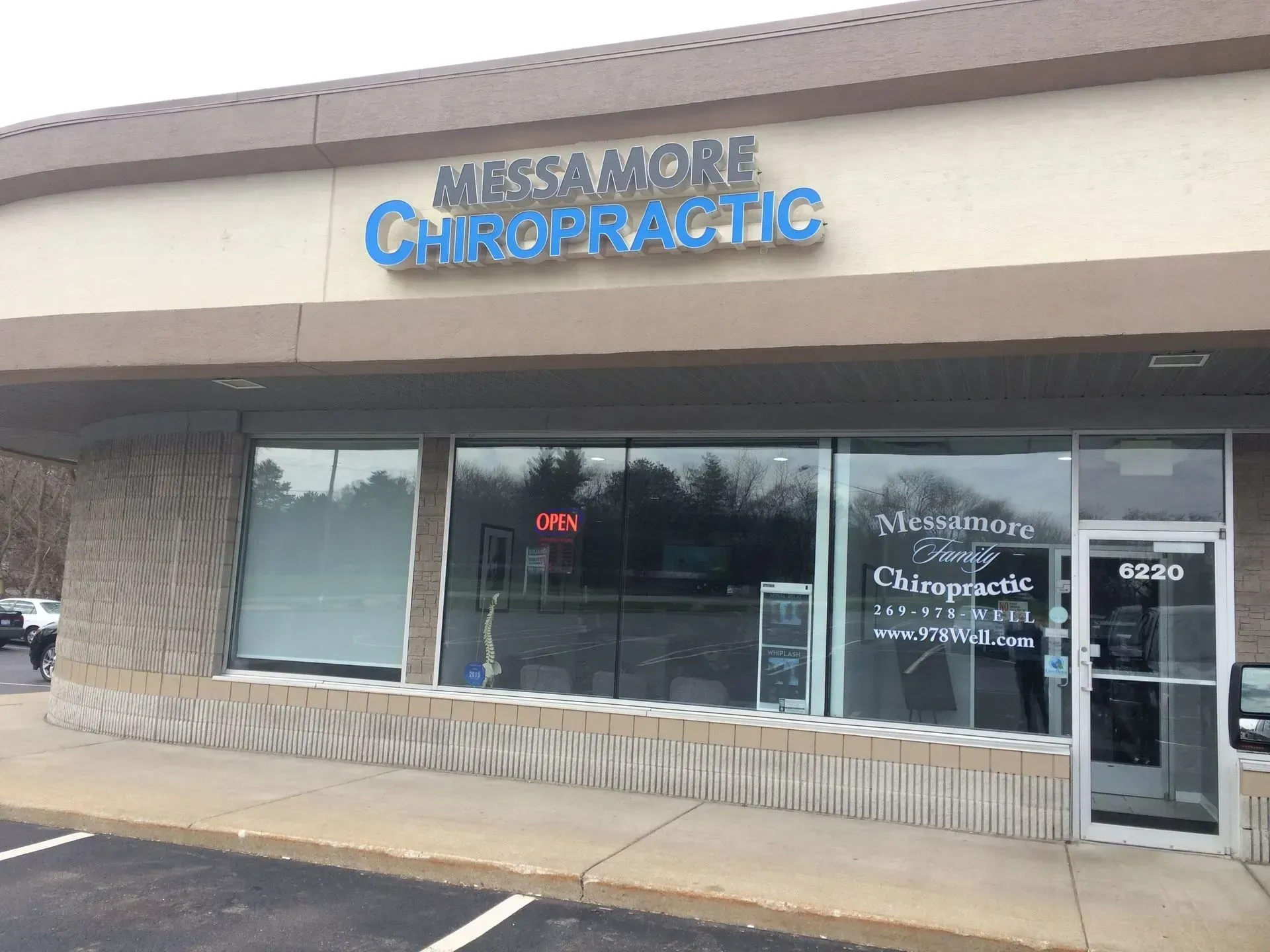 Exterior of Massa & More Chiropractic office with blue signage above windows.