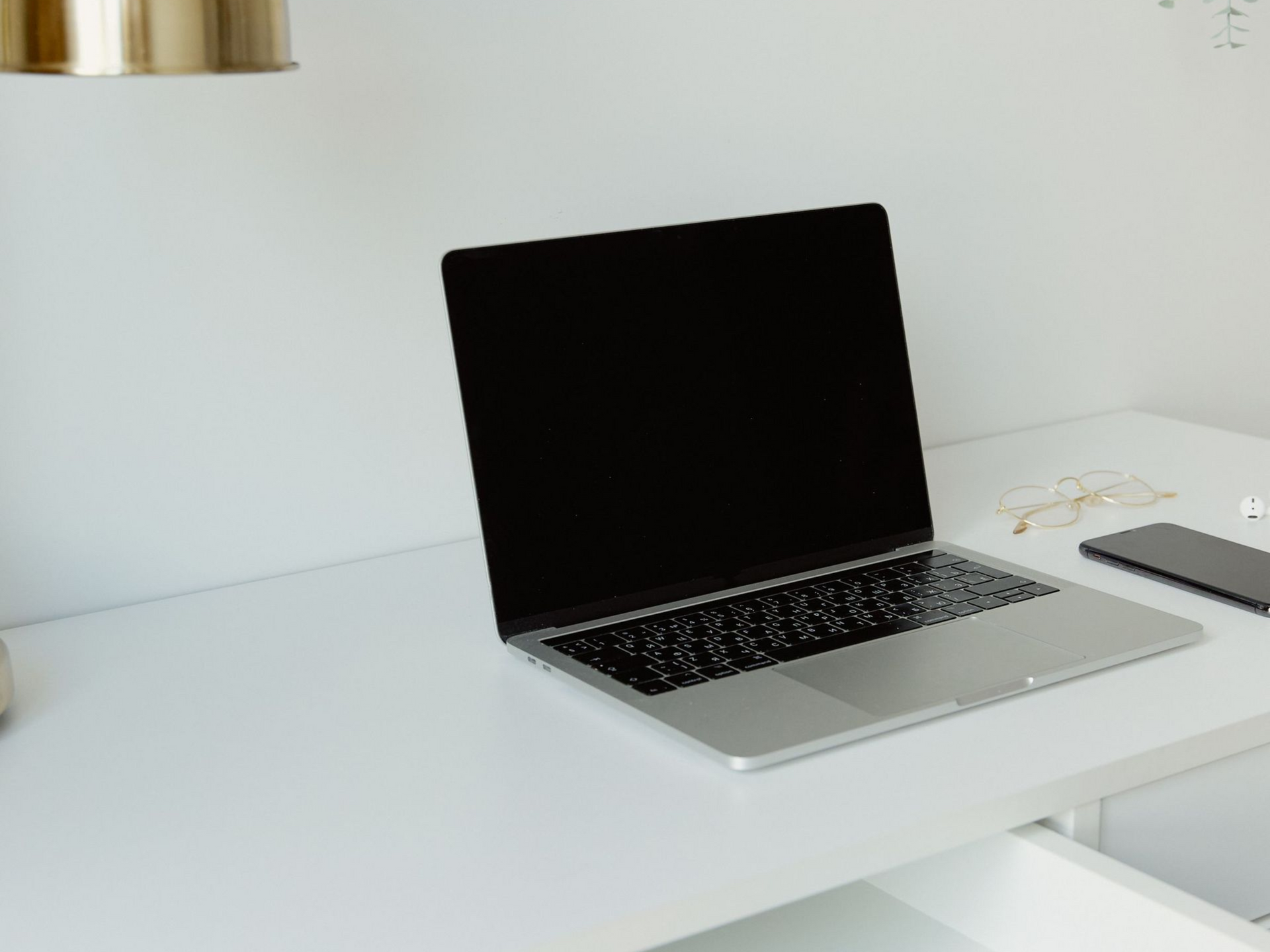 Woman sitting at a table looking at her laptop