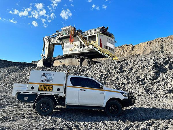 McPhee Diesel Mechanic ute next to large excavator