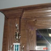 Wood-paneled wall with a trophy beside a doorway