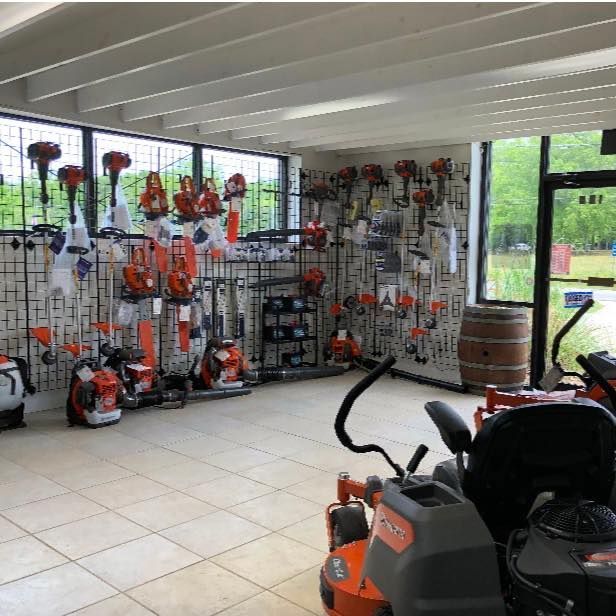 A large room with a lot of lawn mower equipment