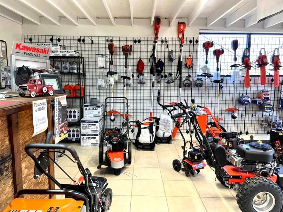 A showroom filled with lots of lawn mower and snow blower equipment.