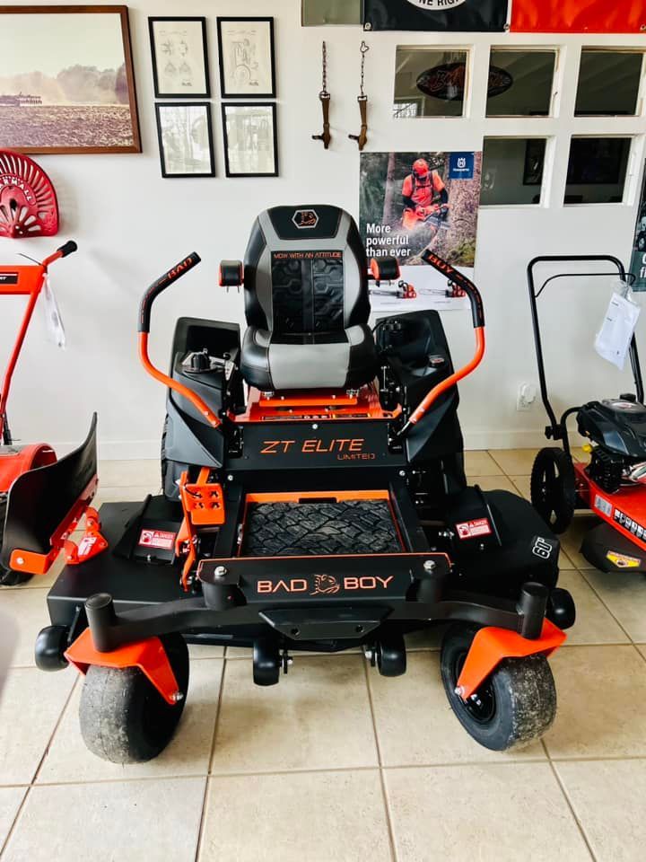 A black and orange lawn mower with the word elite on it