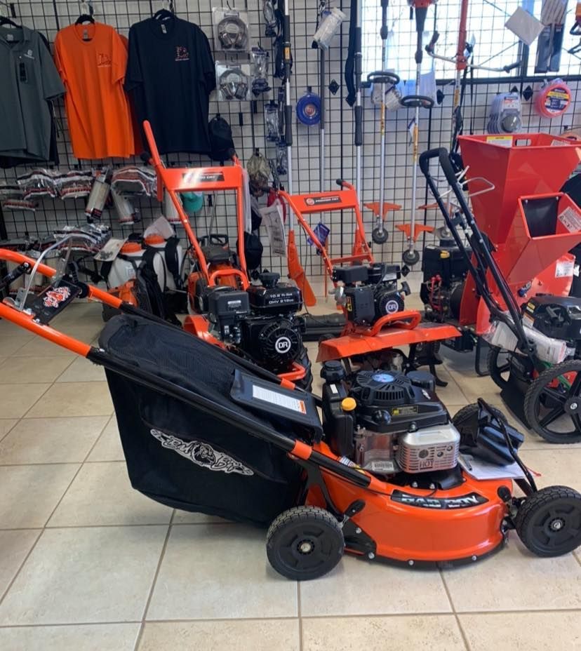 A lawn mower is sitting on the floor in a store