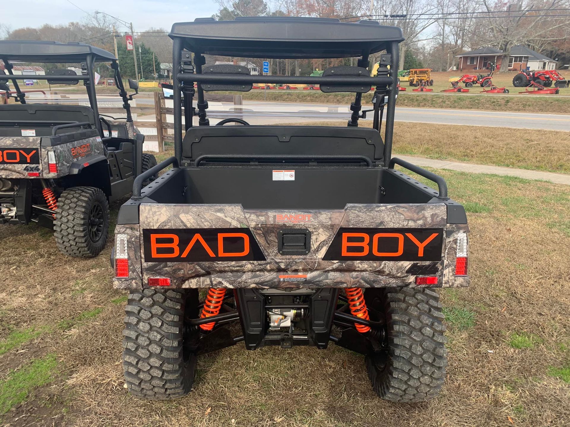 A bad boy utility vehicle is parked in a grassy field.