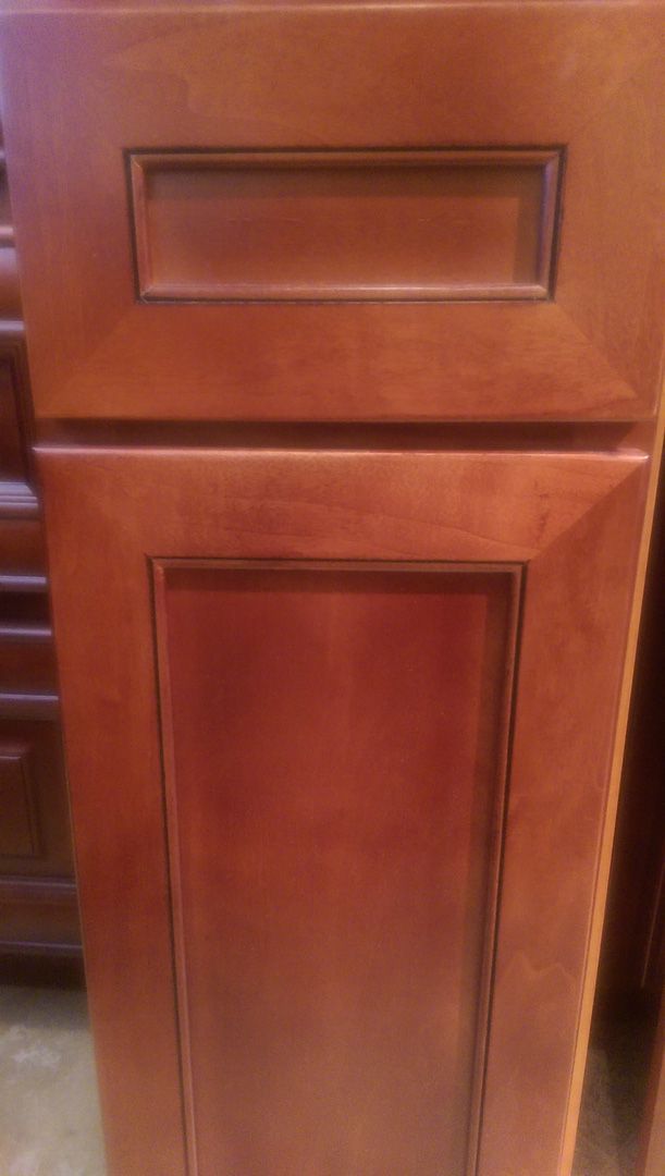 A close up of a wooden cabinet door in a kitchen.