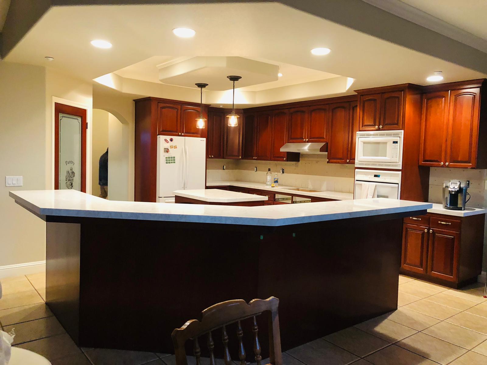 A kitchen with a large island in the middle of it