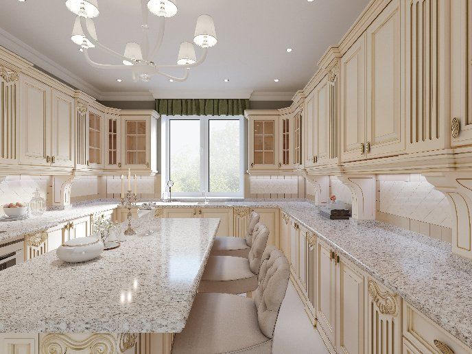 A kitchen with white cabinets and granite counter tops.