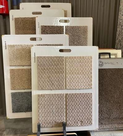 A bunch of carpet samples are stacked on top of each other