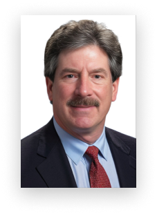 A man with a mustache is wearing a suit and tie