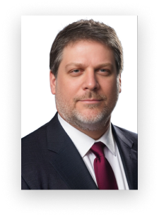 A man with a beard wearing a suit and tie