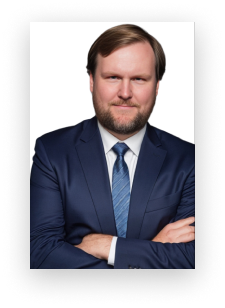 A man in a suit and tie with his arms crossed