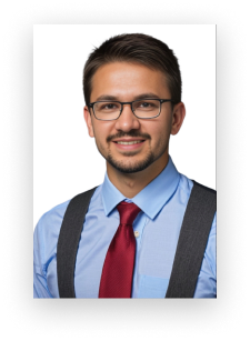 A man wearing glasses and suspenders is smiling for the camera