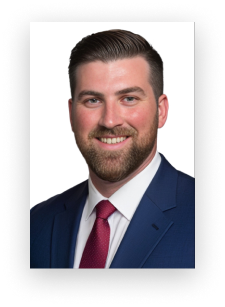 A man in a suit and tie is smiling for the camera
