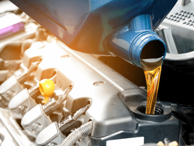 Technician Pouring Engine Oil