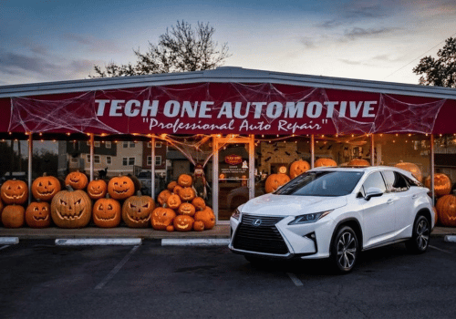 Tech One Automotive repair shop decorated with glowing jack-o'-lanterns and spiderwebs