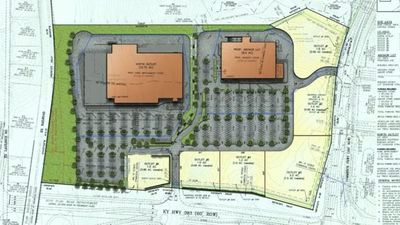 Site plan map showing two orange buildings, parking lots, trees, and surrounding roads on a gray-green parcel.