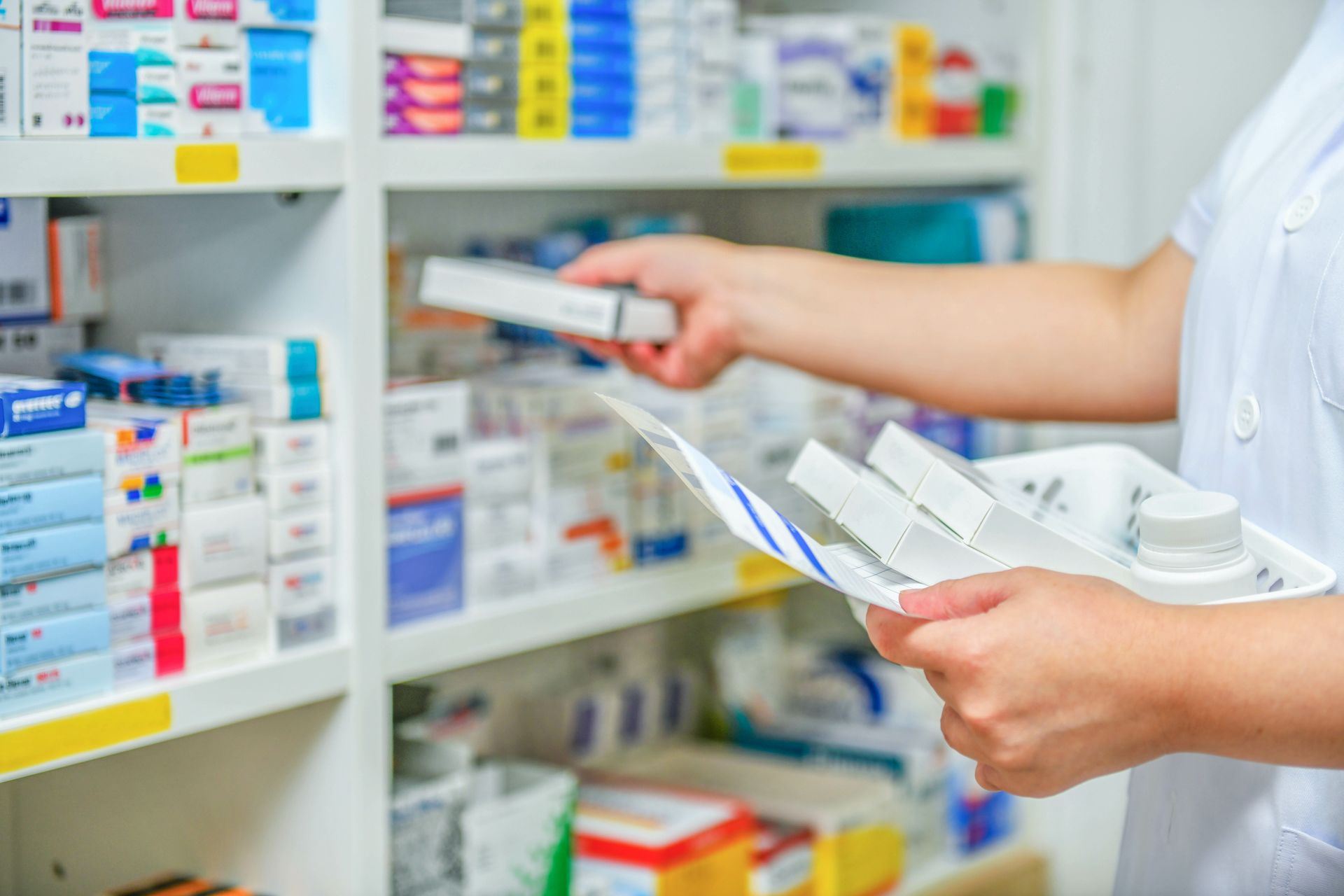 A person is looking for a medicine in a pharmacy.